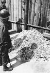 American soldiers view a pile of human remains outside the crematorium in Buchenwald.
