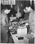 American soldiers from the First Army sorting through jewelry, including gold fillings, taken by the SS from prisoners in the Buchenwald concentration camp.