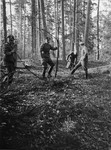 SS officers clearing an area to erect a gallows in the forest near Buchenwald.