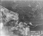 An aerial photograph of Buchenwald concentration camp showing the destruction of the munitions factory and storage area of the camp by American bombers.