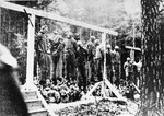 Twenty concentration camp prisoners, most of them Jewish, hang on gallows in a forest near Buchenwald after the murder of a German policeman.