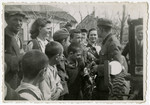 A German soldier meets young Hungarians in Szeged.