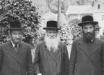 Three religious Jews pose on a street at a resort in the Tatra Mountains.