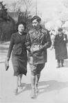 Josef Kaplan and Halina Semadar walking in the streets of Warsaw.