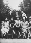 A group of teenage girls who are members of the Hashomer Hatzair Zionist youth movement, pose on a park bench in Piotrkow Trybunalski.