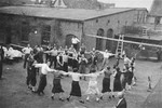 Members of a Zionist collective in Lithuania dance outside in a courtyard during a Shavout holiday celebration.