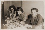 Jewish DPs work at a table outside the employment office at the Schlachtensee displaced persons camp.