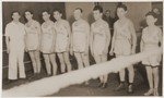 Group portrait of members of an athletic team with their coach at the Landsberg displaced persons camp.