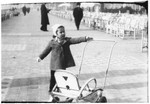 Esther Almer stands by a baby carriage on the Promenade des Anglais in Nice.