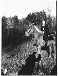 Faigel Lazebnik poses while on horseback.

She set up the camera and tripod (the shadow of which can be seen in the foreground) and had a friend shoot the photograph.