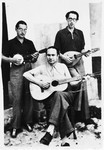 Three internees play stringed instruments in the Campagna internment camp.