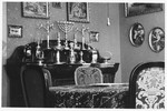 View of the silver religious articles on the dining room buffet in the home of Piroska and Hugo Rosenberger.
