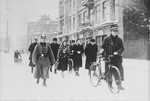 German police escort a group of Jews along a snow covered street during a deportation action in Zawiercie.