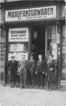 Jewish owners and employees of the M. Damm textile company in Vienna pose in front of their business.