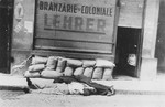 The bodies of Jews killed during the Iasi pogrom lie on the pavement in front of a Jewish-owned business.