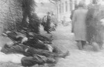 The bodies of Jews killed by Romanian soldiers and police lie against the wall of police headquarters.