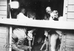 [Romanian military physicians examining Jews during the stop of the Iasi-Calarasi death train in Sabaoani.]