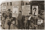 Jewish refugees hold up signs in German during an electoral campaign for an unidentified Zionist representative body.