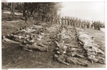German POW's are forced by Soviet guards to rebury corpses exhumed from a mass grave in Czechoslovakia.
