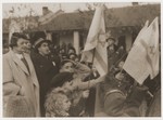 Harry Fiedler and other students wave Zionist flags during a celebration at the Kadoorie School.