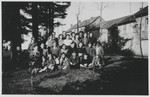Group portrait of Jewish and non-Jewish refugee children sheltered in various public and private homes in Le Chambon-sur-Lignon during World War II with some of the French men and women who cared for them.