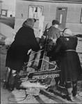 Jews transport their wood rations to their homes in the Kovno ghetto.