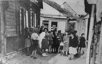A group of Jewish women converse in an alley outside the only barbershop in the Kovno ghetto.