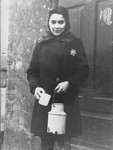 Portrait of a young girl holding a milk can in the Kovno ghetto.