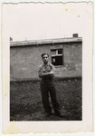 Max Beker, a Jewish and Polish prisoner-of-war, stands outside a barracks of Stalag VIIIA.