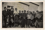 Group portrait of Polish prisoners-of-war holding musical instruments.