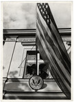An American flag hangs outside the shattered window of the American embassy in Warsaw during the siege of the capital.