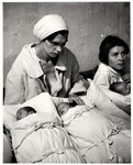 Two Polish mothers pose with their newborn infants during the siege of Warsaw.