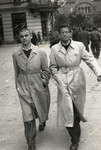 Josef Dekalo and Marcel Confino walk down a street in Sofia wearing Jewish badges.