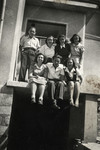 A group of young Jewish Bulgarians pose on the ledge of a building.