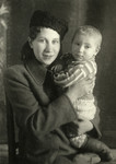 Studio portrait of Rywka and Benjamin Markowicz. 

Benjamin is wearing boots made by his father and Rywka wears a Russian hat to appear more Russian.