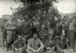 Group photograph iof Jewish refugees in Bukhara, some holding Yiddish newspapers.
