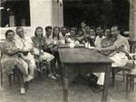 A group of Polish Jewish refugees and local friends enjoys a cup of tea at Chai Hana.