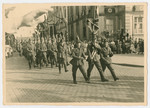 Nazis march down a street in Fulda during a May Day Nazi party parade.