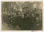 Children line a street to cheer on a Nazi May Day parade.