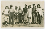 Group portrait of Jewish children in their Purim costumes [probably in the Ben Shemen agricultural school].