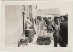 Original caption:  Inmates are stripped and sprayed with DDT.