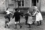 Regina Anders pictured right) plays with children at a day care in postwar Berlin.