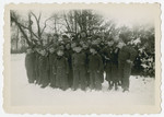 Elementary school boys, many of them Jewish children in hiding, pose in the snow outside the Chateau de  Beloeil.