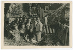 A group of men, women and children poses in a garden of the Zeilsheim displaced persons camp.