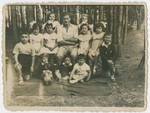 Yehuda Bielski poses with a large group of young children in the woods near Nowogrodek.