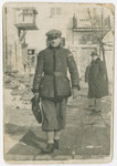 Yehuda Bielski walks down a street in prewar Nowogrodek.