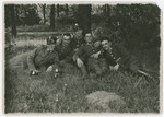 A group of Polish soliders relaxes under a tree.

Lt.