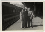 Three "Buchenwald Boys", teenage survivors of Buchenwald, pose on the platform of a train station in Switzerland.