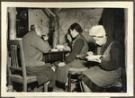Two German families eat lunch in their bunker in the celler of their destroyed house of Freiedrichsstrasse 15-16, Wurselen.