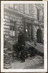 Joseph Eaton, an American soldier and Jewish German emigre poses in front of the rubble at Fuertherstrasse 6 in his hometown of Nuremberg.